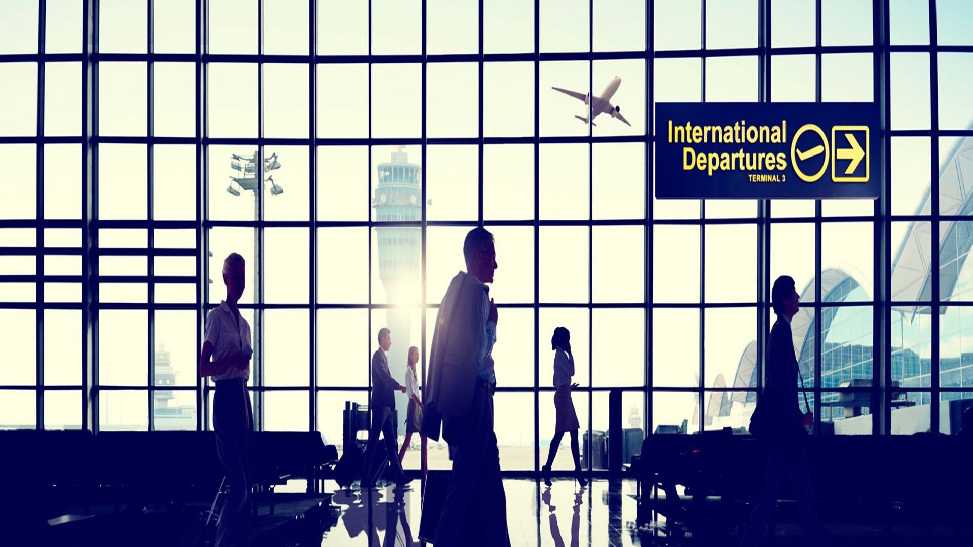 Aircraft at airport gate with ground operations and transport infrastructure 